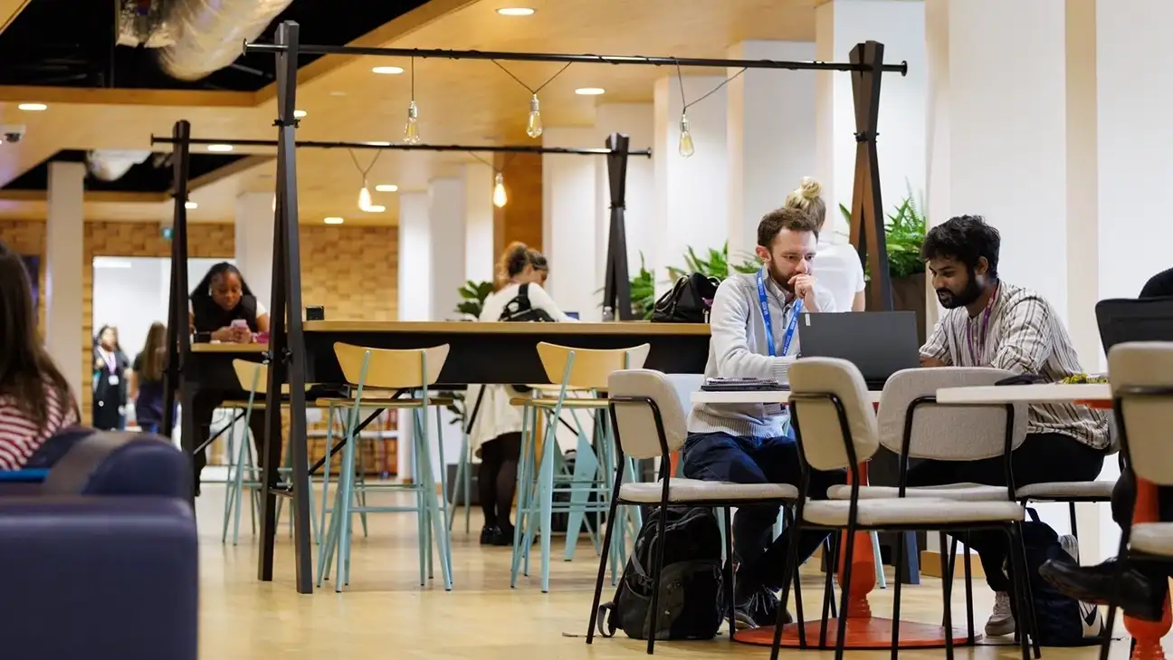 Two people sitting down at tables