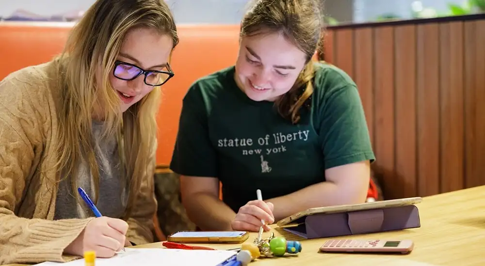 Two students working at a table