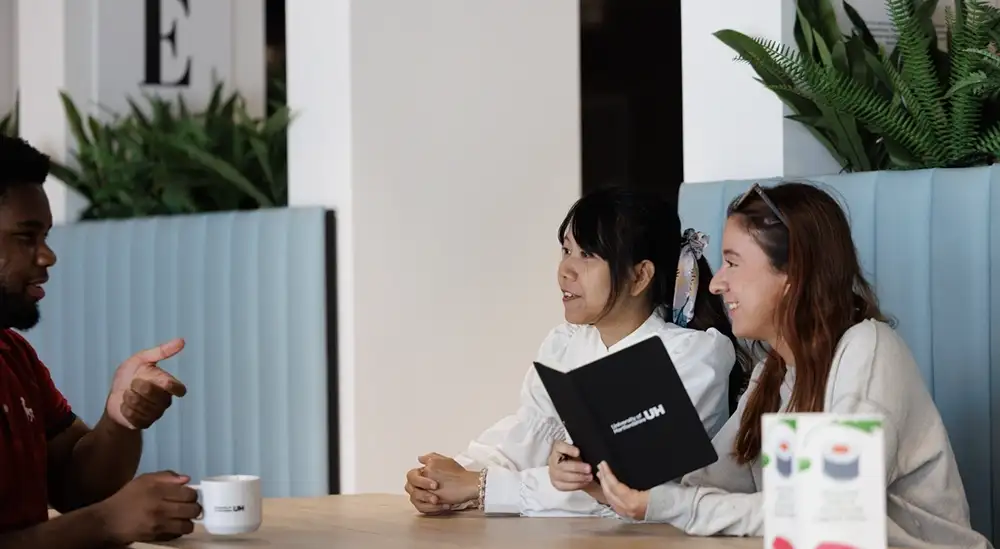 People looking at menu on table