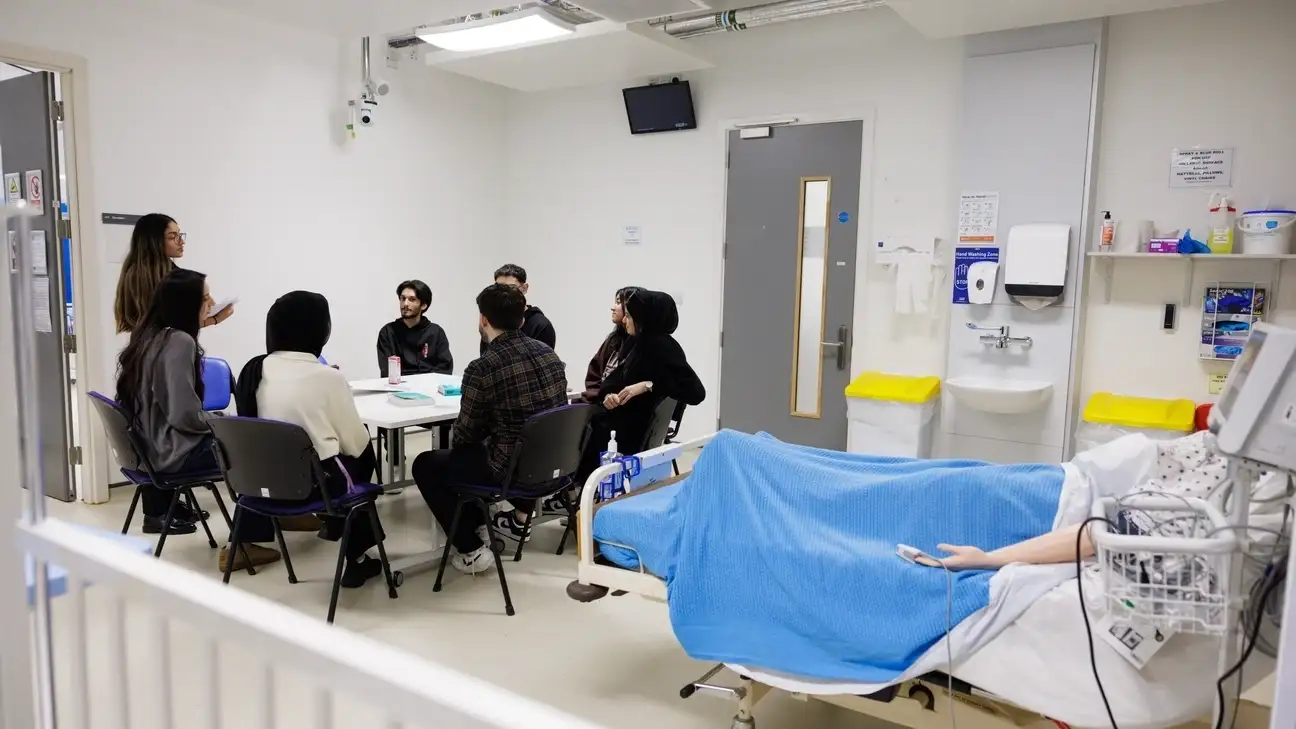 A group of students sitting round a table working together