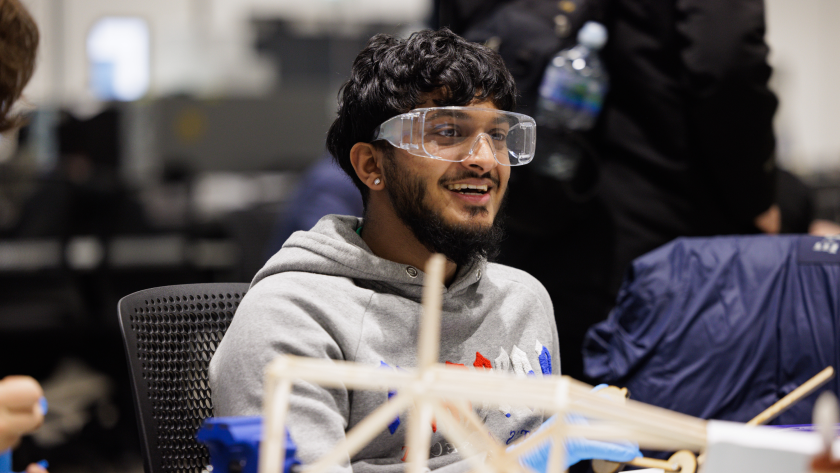 A student smiling wearing safety specs