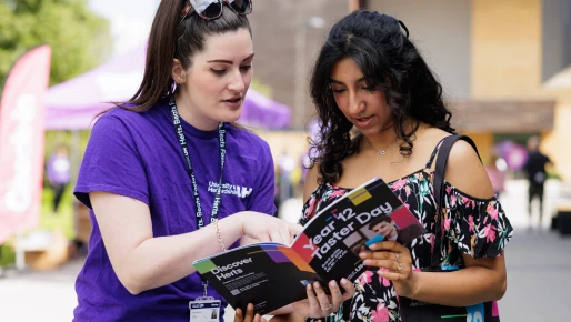 Student and guide tour looking a book 