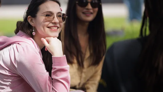 Students outside smiling