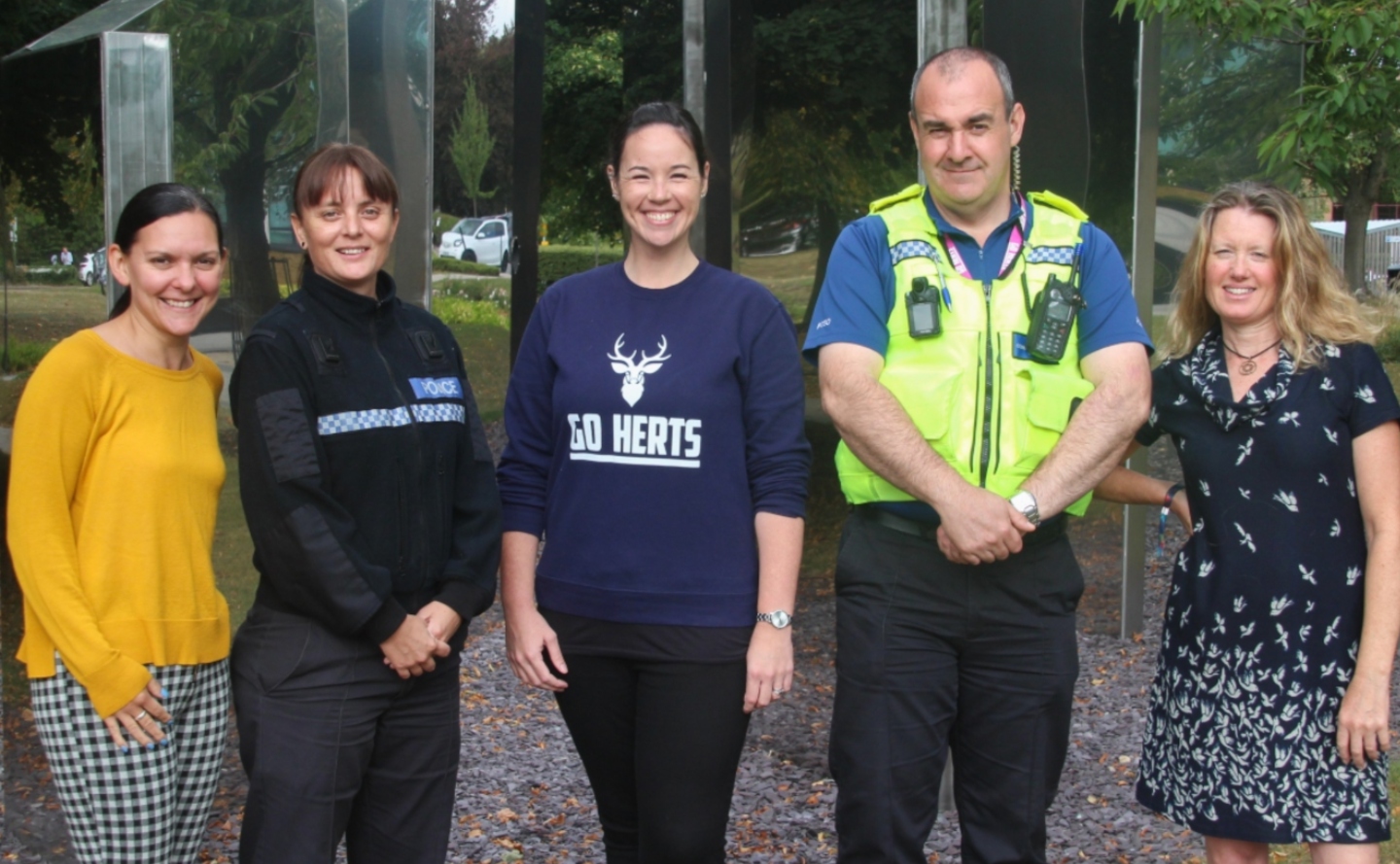 Group of staff smiling outside