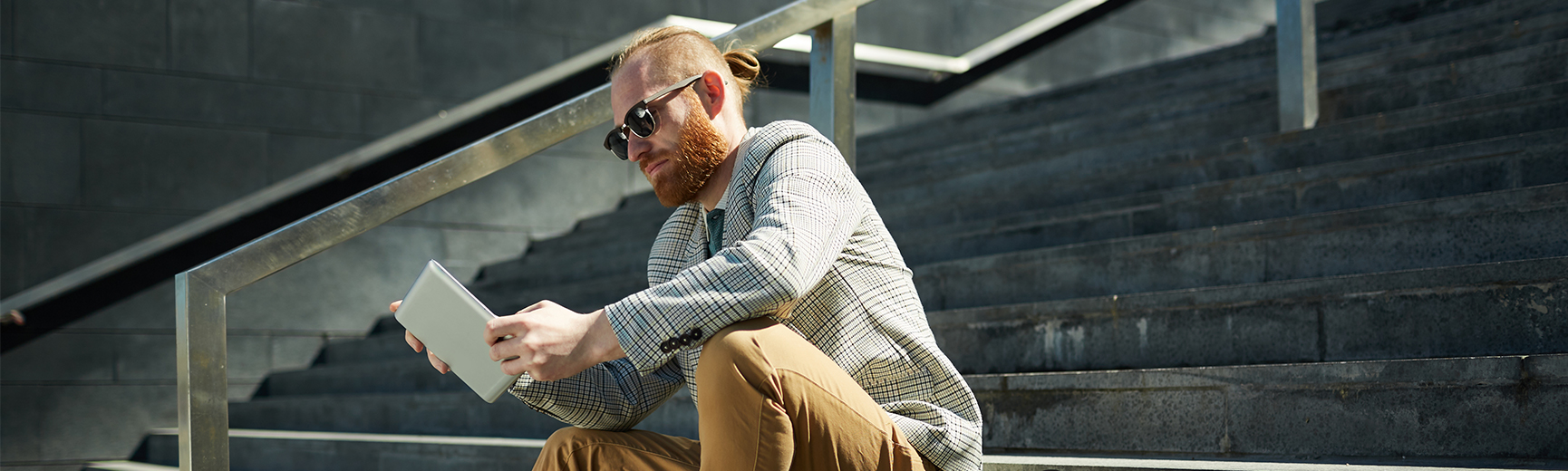 Man on a tablet on stairs