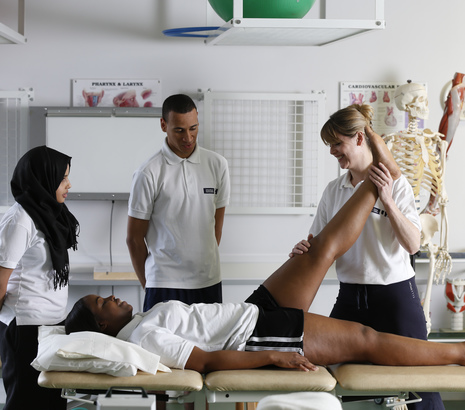 Physiotherapy students looking after patient