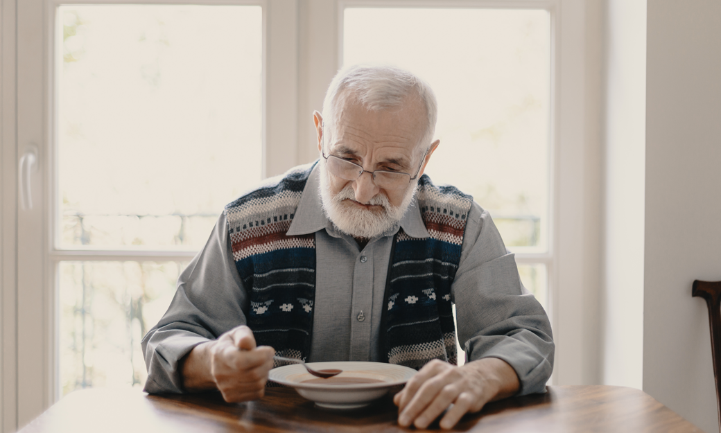 Older adult eating a meal alone