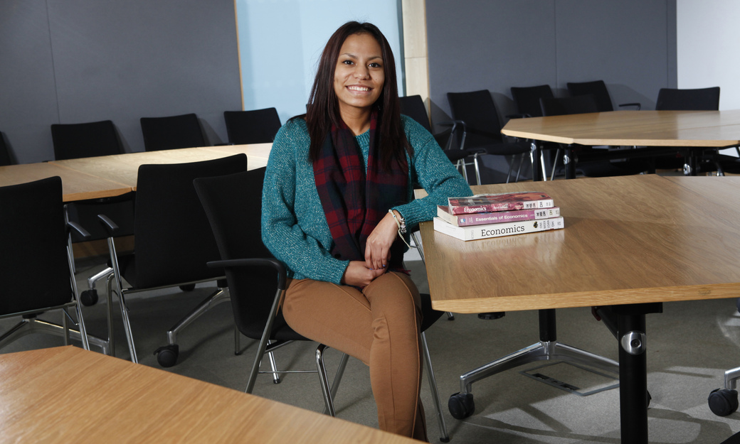 a female student in a classroom with economics books from the library