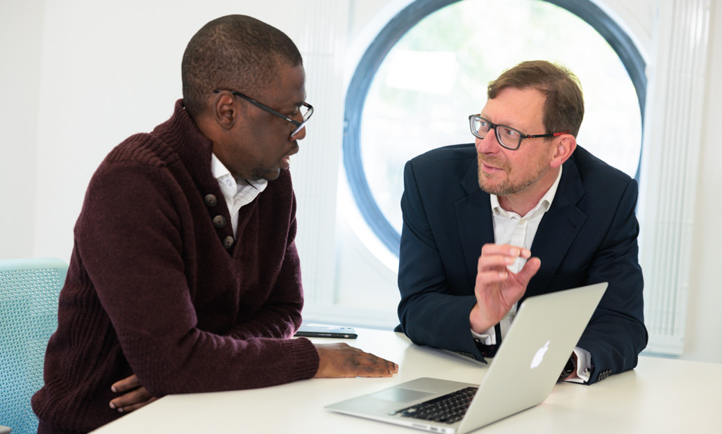 Sola and a colleague talking intently together