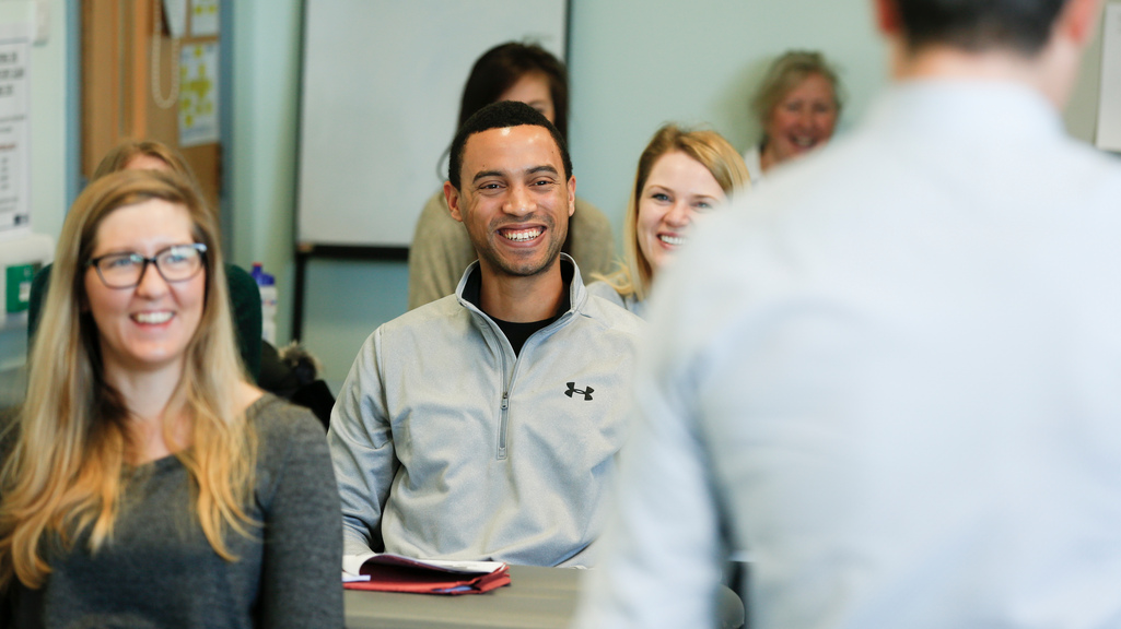 Herts student smiling in lecture