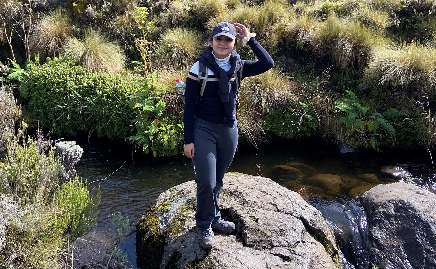 A picture of Esha Sheth standing on a rock