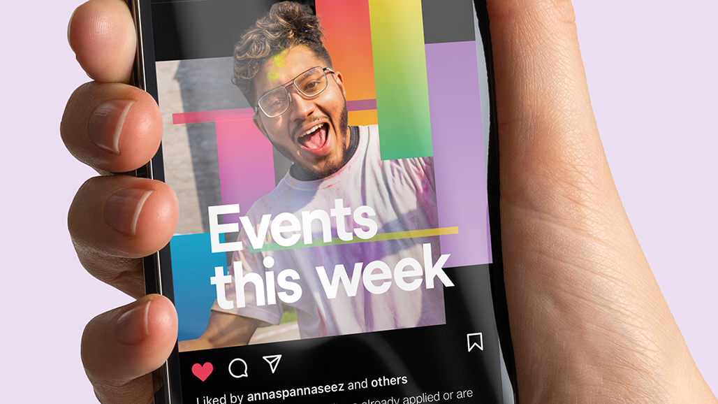 hand holding an iPhone, displaying a social media post by the university of hertfordshire