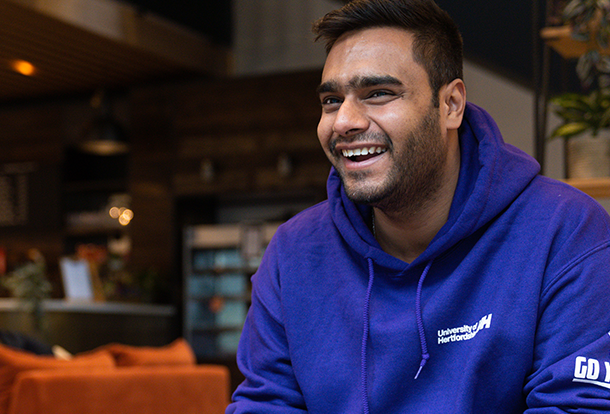 smiling student in uni hoodie