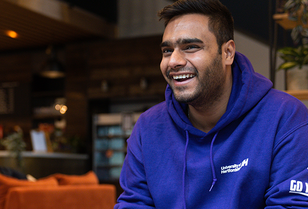 smiling student in uni hoodie 