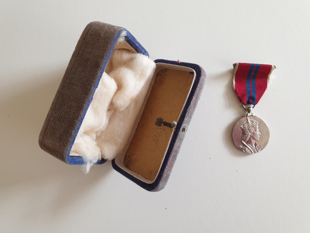 Medal next to a blue velvet box