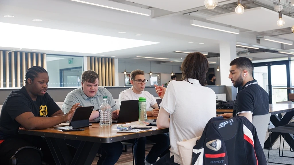 Students sat around a table talking