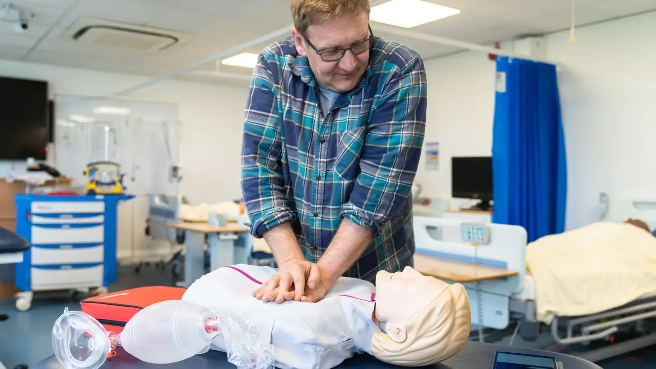 A student performing CPR on a dummy