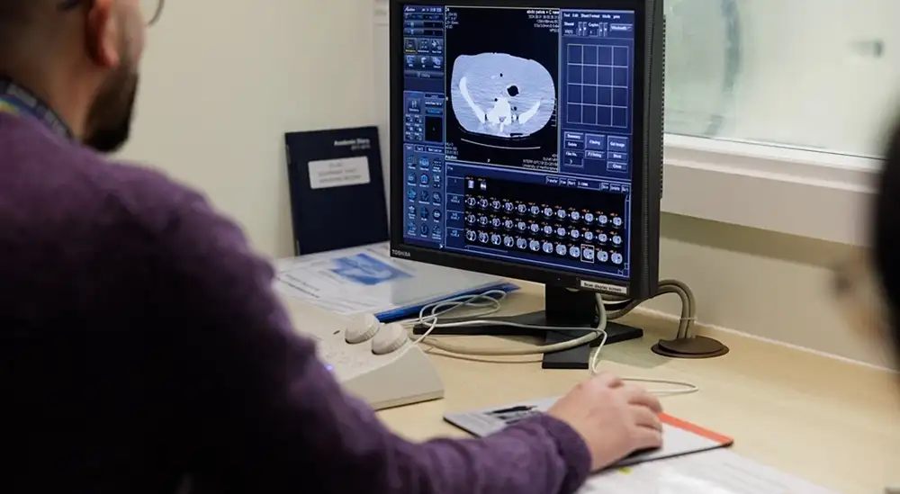A person looking at an MRI image