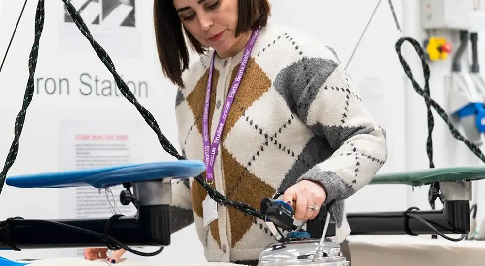 A student using an iron