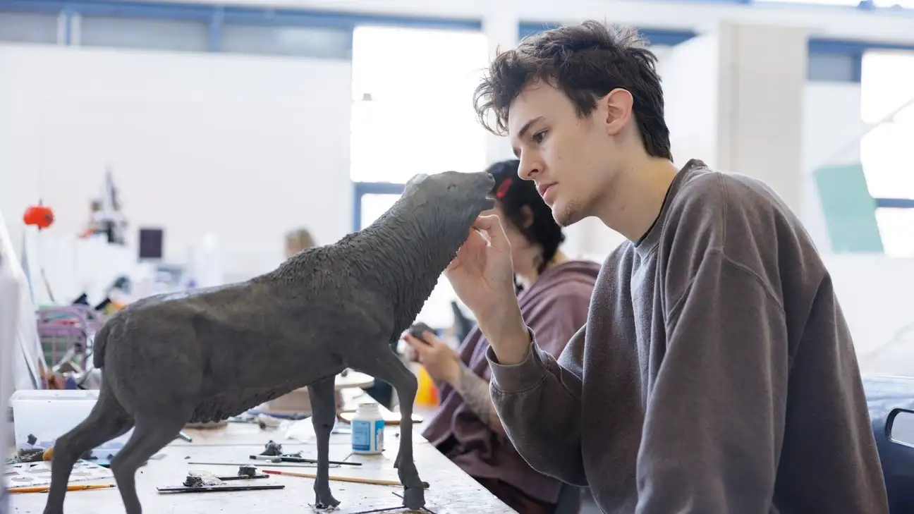 A student creating a model lamb