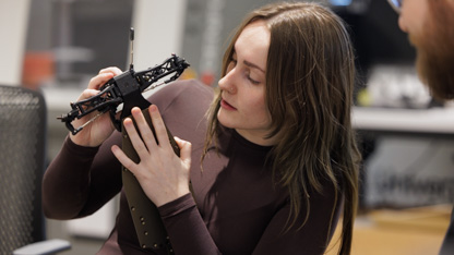 Student looking at engineering model