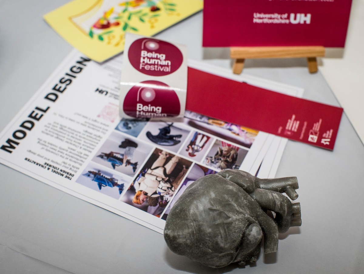 Arrangement of a 3D printed heart and bookmarks on white table