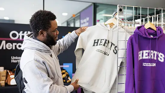 Person looking at hoodie in shop