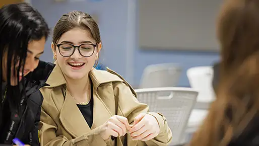 Student smiling talking to peers