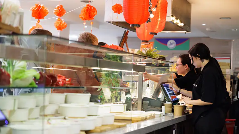 People eating at a food hall