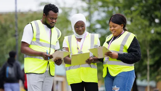 Students in high vis jackets working together