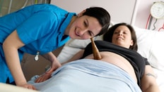 A Midwife examines an expectant mother