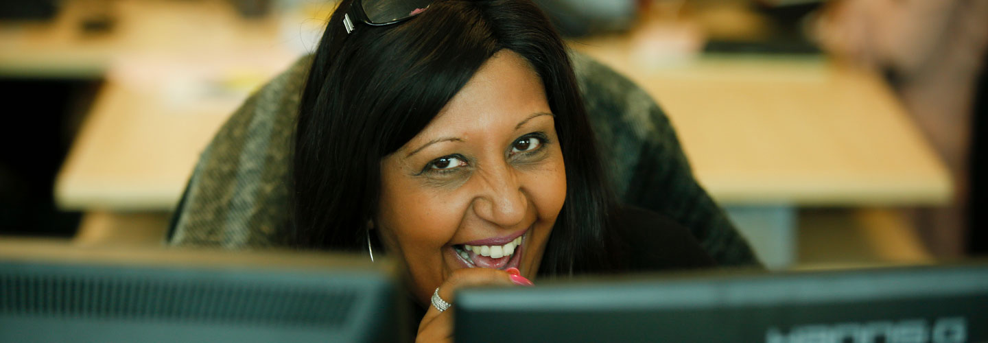 A member of staff smiling