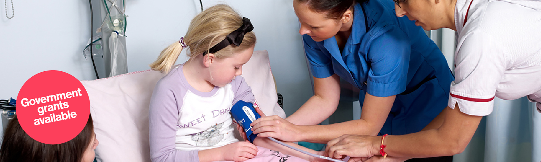 nurse checking child's blood pressure