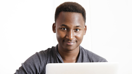 Male student on Mac laptop