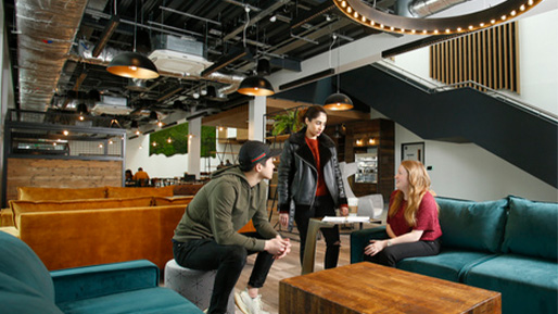 Three students talking in social area