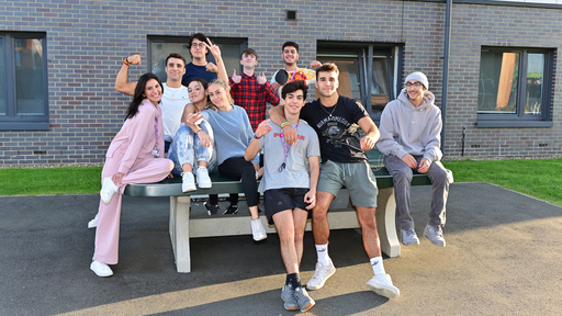 student wearing a Herts sweatshirt smiles