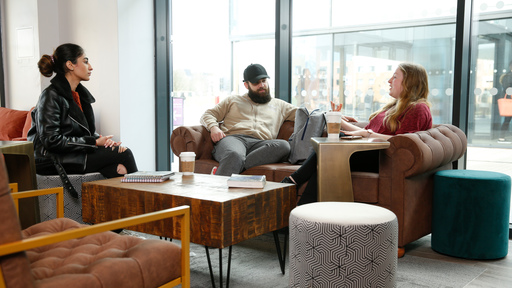 Male and female students on sofa