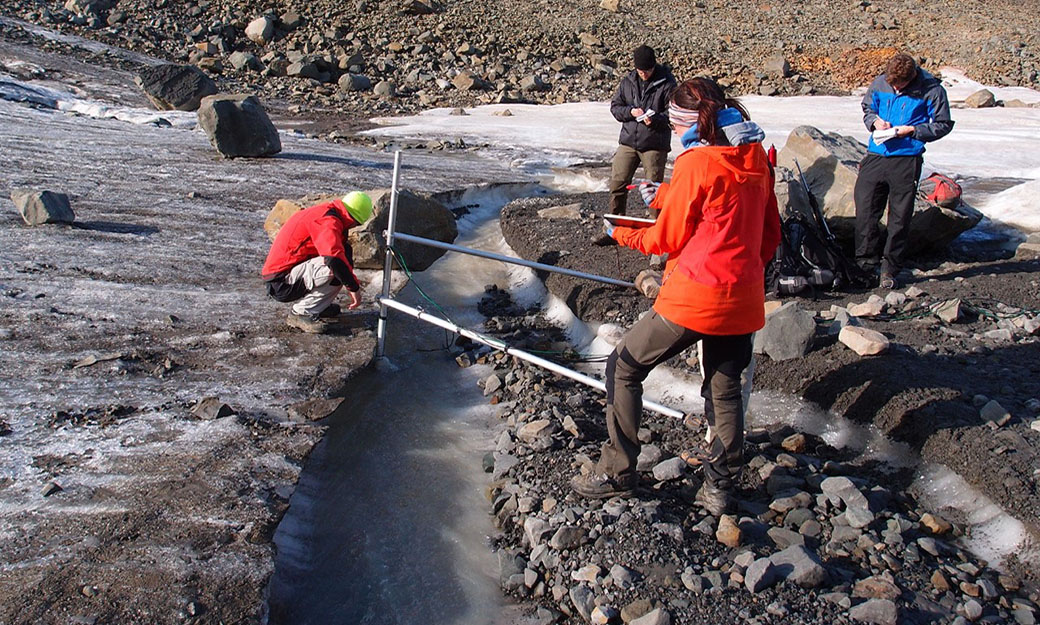 students measuring a glacier