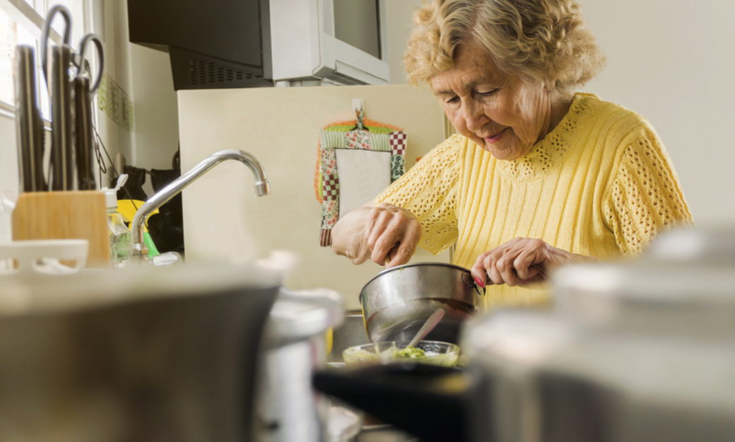 Older adult making a meal in her kitchen