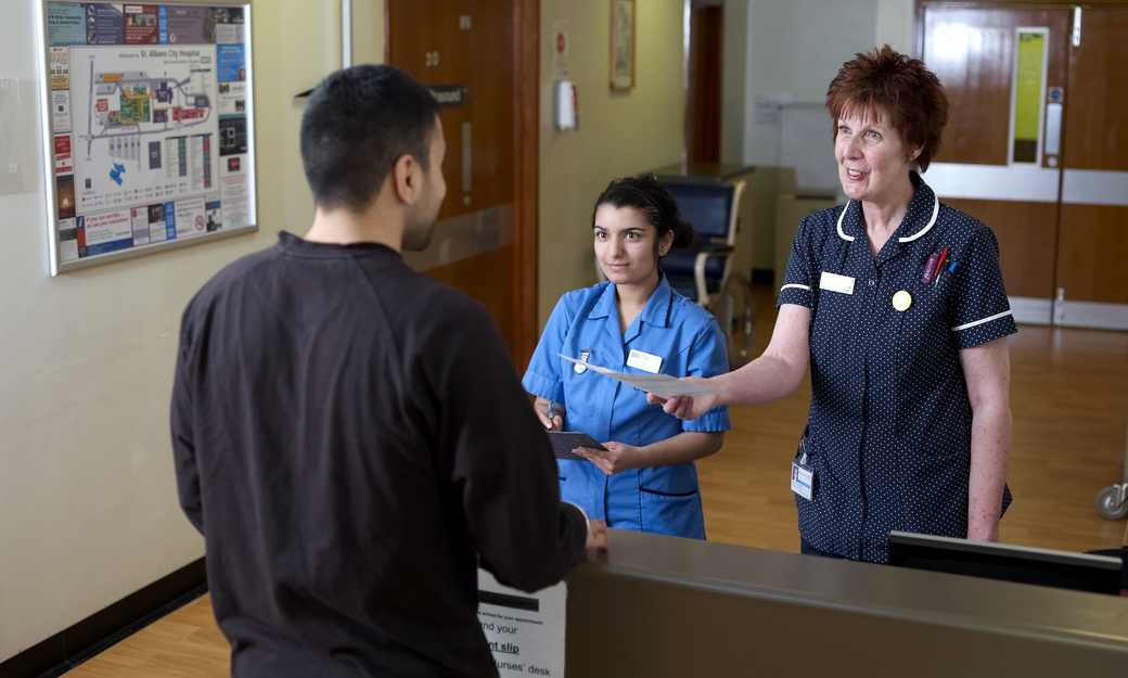 a student nurse working with a qualified nurse on work placement 
