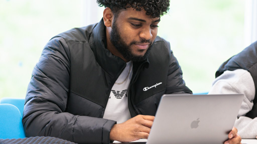 Male student working on his laptop