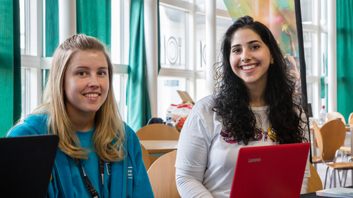 Two female students smiling 