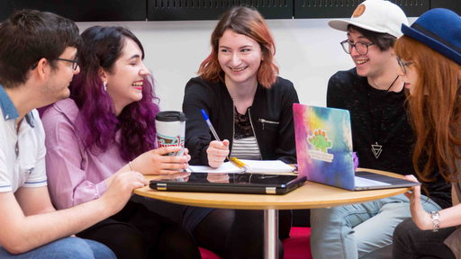 Group of 5 students talking together