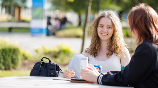 Two students sat outside