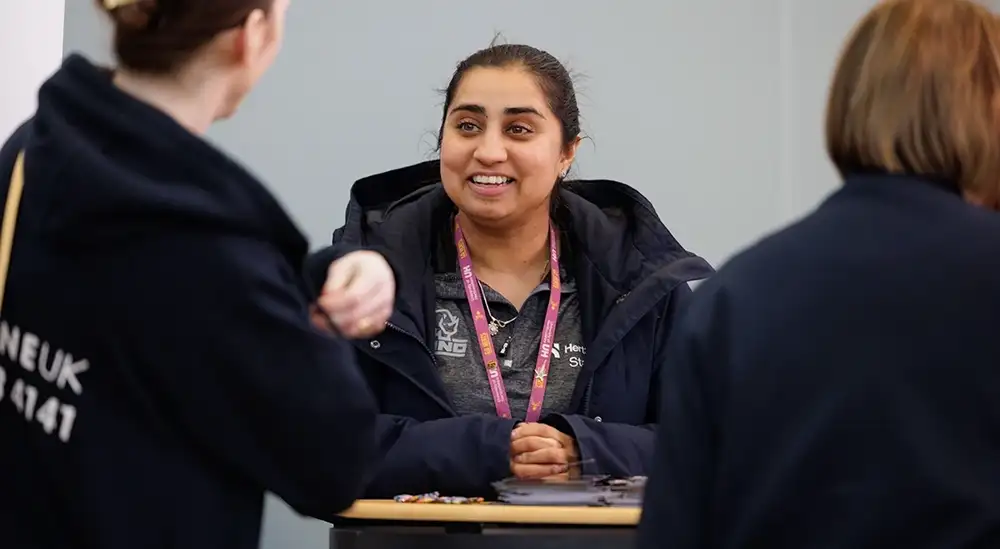 Students talking to a member of the Herts Squad