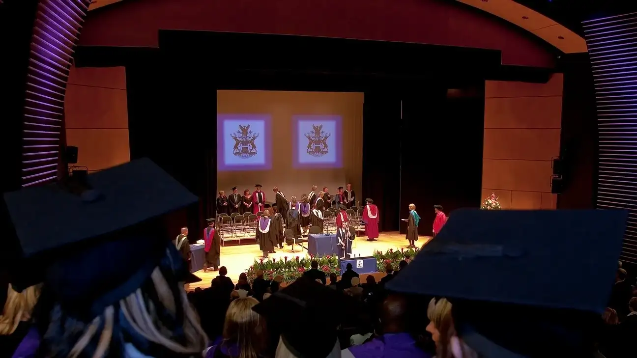 Students in the auditorium as part of a ceremony
