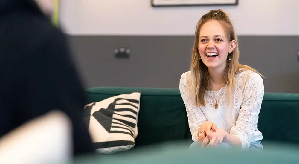 A student smiling and laughing