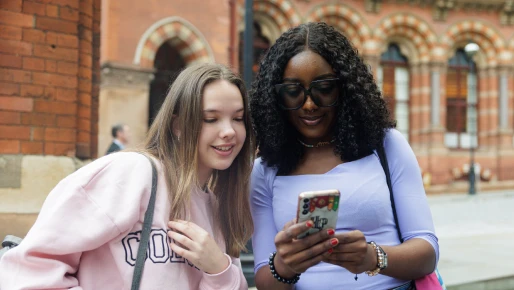 Two students looking at phone