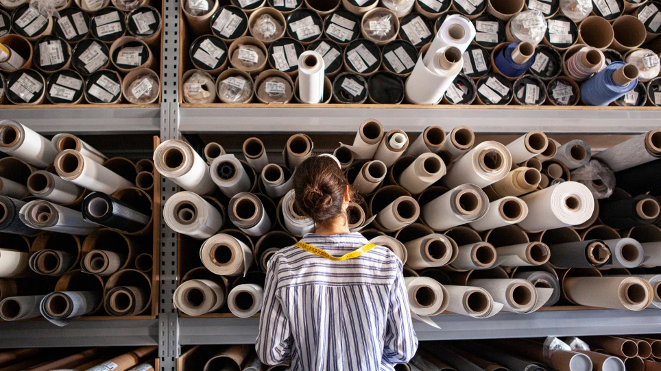 Person looking at rolls of fabric
