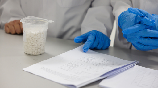 Pharmacist putting medicine in bag